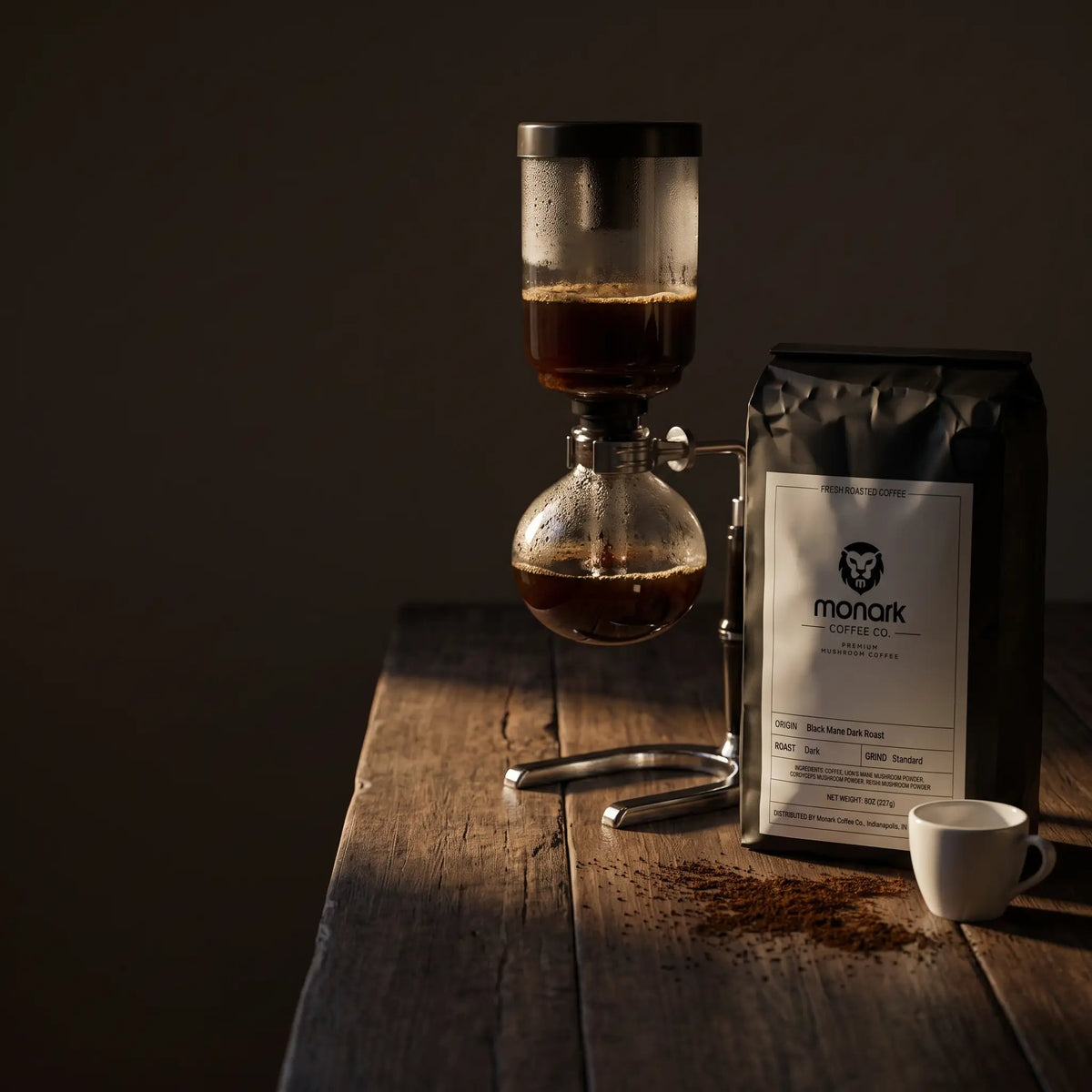 Monark Black Mane Dark Roast beside a siphon brewer