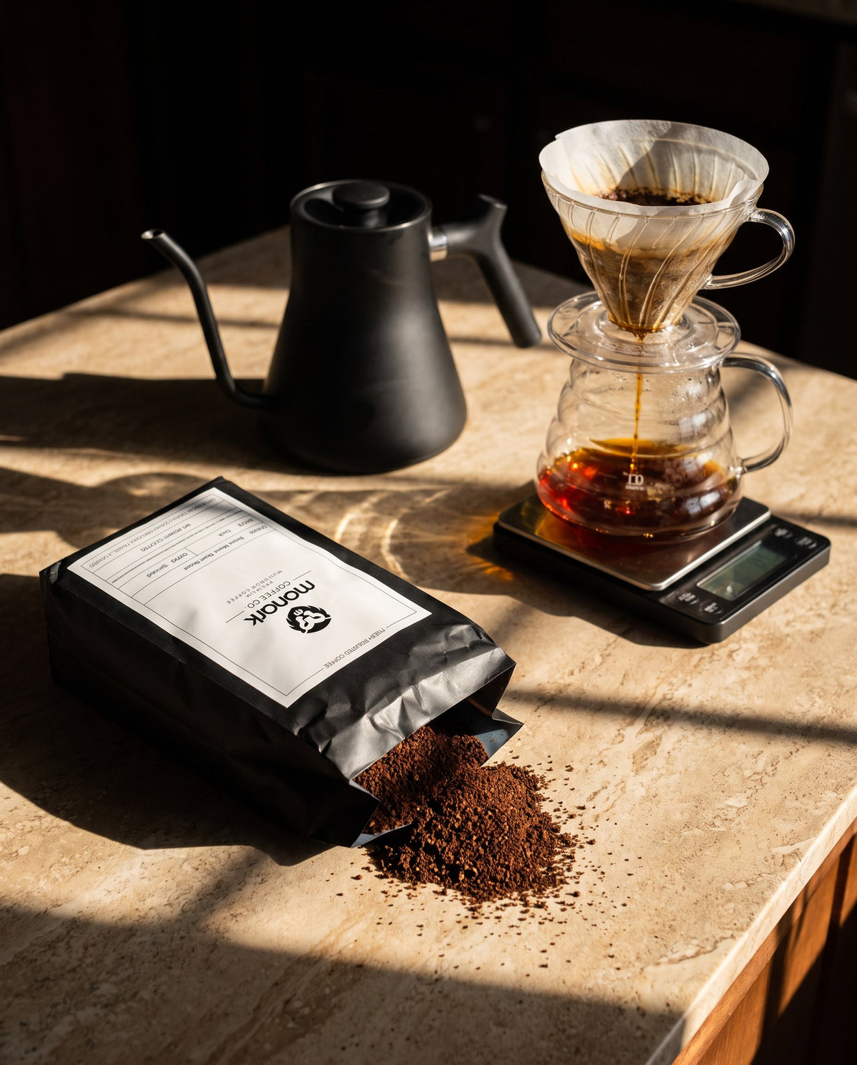 Monark ground coffee with a kettle and pour-over on a scale